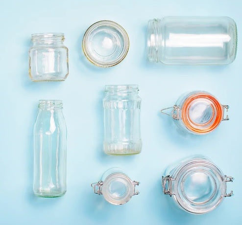 Mixture of glass jars displayed on a blue background