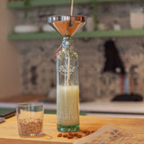 Photo of a beverage being poured into an eco-friendly bottle named the Philos bottle